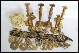 A collection of 19th century candlesticks together with a collection of horse brasses of assorted