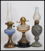 A collection of 3 oil lamps to include a Duplex with clear glass reservoir,