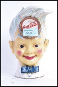 A vintage style cast iron Coca Cola sprite money box,