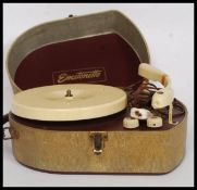 A vintage Emstonette two tone portable record player in original case with bakelite deck with BSR