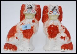 A pair of late 19th / early 29th century Staffordshire fireside dogs,