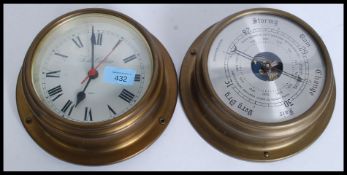 A contemporary vintage style brass effect bulkhead barometer together with matching quartz clock.