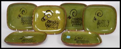 A set of six studio pottery plates in a wonderful rich green glaze depicting a ram to each plate,