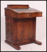 A Victorian walnut Davenport desk with hinged top having sectional interior.