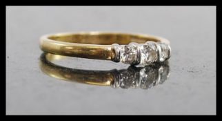 An 18ct gold ladies 3 stone diamond ring. The round cut 3 stones approx 25pnts. Total weight 2.