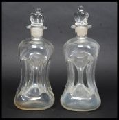 A pair of vintage Holmegaard Kluk Kluk clear glass decanters complete with crown / king top