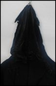 An retro full length 1970's black velvet cloak,