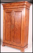 A 19th century French fruitwood - burr walnut armoire wardrobe being raised on bracket feet with