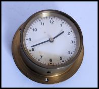 A 20th century  small brass ships bulkhead clock with glass facia (appears to be in working