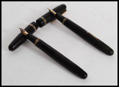 A vintage Swan Mabie Todd Ltd self filler  fountain pen with 14ct gold nib in black with gold trim