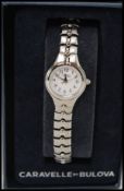 A Caravelle by Bulova ladies wristwatch with white dial set on stainless steel bracelet complete in