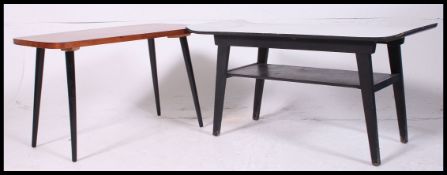 A retro surfboard painted coffee table along with another coffee table with a teak top raised on