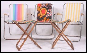 A collection of seven ( 7 ) vintage / retro folding metal framed and canvas camping chairs and