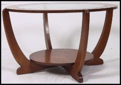 A vintage teak 1970's atomic style oak quarter veneer round coffee table with glass insert top and