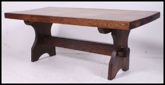 A 20th century rustic oak coffee - occasional  table together with a Mr Chippy oak telephone table