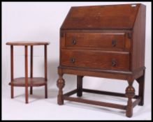 A 1930's Solid oak bureau having a fully appointed interior with drop down front above three