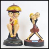 Two vintage style Art Deco inspired cast iron painted doorstops.