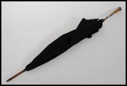 A Victorian rhino horn handled and silver collared ladies parasol / umbrella.