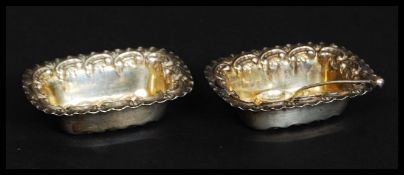 A good pair of hallmarked silver art nouveau salts, with matching spoon.