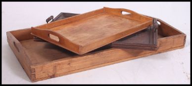 A collection of three vintage graduating unassociated butlers trays, ranging from Edwardian in age.