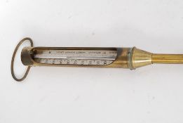 An early 20th century brass Negretti & Zambra ground thermometer / barometer marked to the stem.