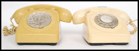 Two vintage retro 20th century ring dial telephones, one in cream,
