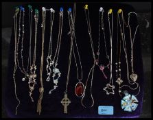 A collection of 14 silver and white metal necklaces and pendants.