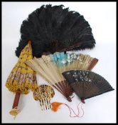 A Tortoiseshell and ostrich feather ladies fan together with a wooden parasol,