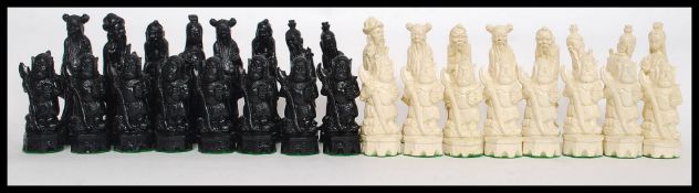 A cased Japanese figural chess set of figures being of a moulded from a resin