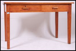 A mid century Air Ministry writing table desk with twin drawers to the frieze frame with squared