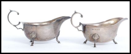 A pair of silver hallmarked creamers. Each raised on hoof feet.