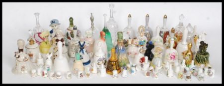 A large collection (1x crate) of assorted glass, ceramic and commemorative china bells.