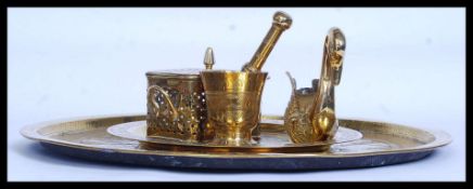 A collection of brass wares to include a large circular wall charger, an incense box,