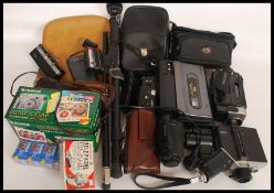 A collection of cameras to include hand held digital video camera along with retro 1980's video