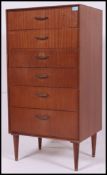 A retro teak effect straight six chest of drawers, raised on stub legs.