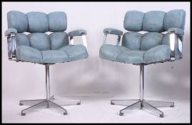 A pair of retro 1970's chrome and blue vinyl upholstered offie swivel chairs.