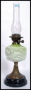 A Victorian high Art Nouveau green glass, gilt metal and ceramic oil lamp. Complete with flue.