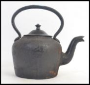 An unusual cast iron heavy kettle, black form, with handle to top and lid.