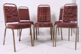 A set of six retro tubular metal framed stacking chairs,