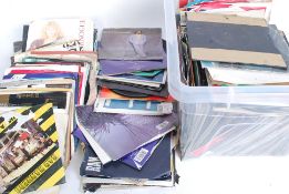 A case of several 45rpm vinyl record singles mainly from the 1980's consisting of various artists