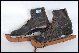 A pair of vintage ice skates with leather uppers complete with laces