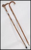 Two walking canes to include a horn topped silver collared bamboo cane along with another