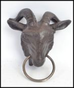 A goat head exterior metal dog leash holder / horse tie. Hand painted.