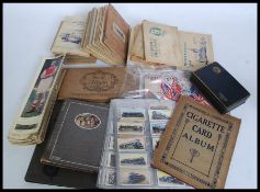 A LARGE collection of vintage Cigarette cards, mostly stuck into assorted albums,