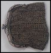 A silver chain mail penny purse, having a cross over clasp stamped to the interior  925.
