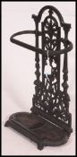 A Victorian Coalbrookdale style cast iron umbrella stand with tray being ebonised.