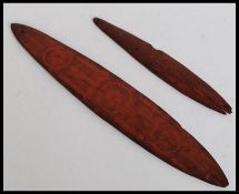 An Aboriginal bullroarer, the flat side incised circles, the domed reverse with linear  circles,