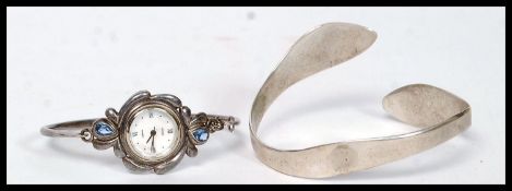 A silver 925 contemporary bangle bracelet together with a silver bracelet with inset roma watch.