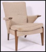 A vintage 1950's retro teak Parker Knoll lounge chair / armchair with angled arm raised on tapered
