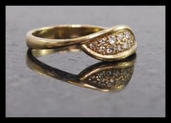 A ladies 9ct gold and diamond leaf set ring. The illustion set diamonds set within a leaf.